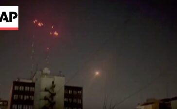 Iran air defenses fire into the sky as Israel strikes Tehran